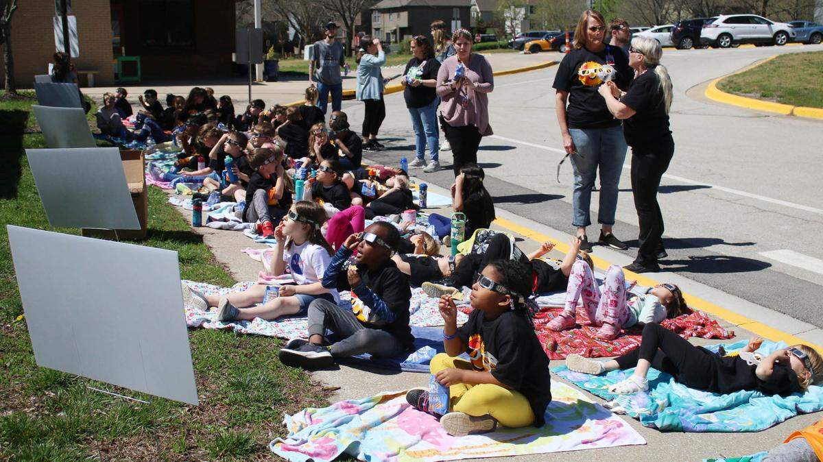 Students at Heatherstone Elementary School in Olathe watch the solar eclipse April 8.