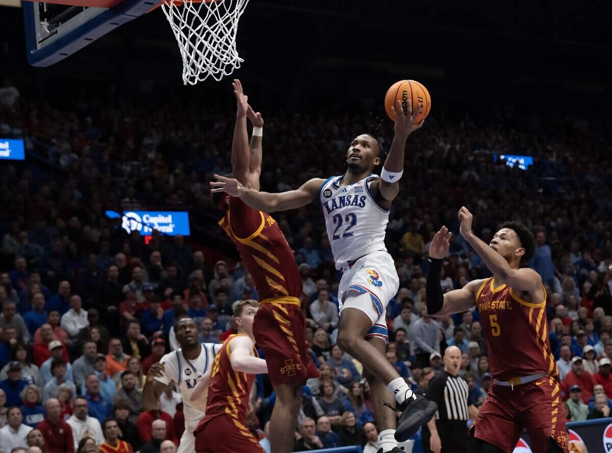 Kansas Jayhawks guard Darryn Peterson (22) shoots as Iowa State Cyclones forward Joshua Jefferson (5) and others defend in the first half on Tuesday, Jan. 13, 2026, at Allen Fieldhouse in Lawrence, Kansas.