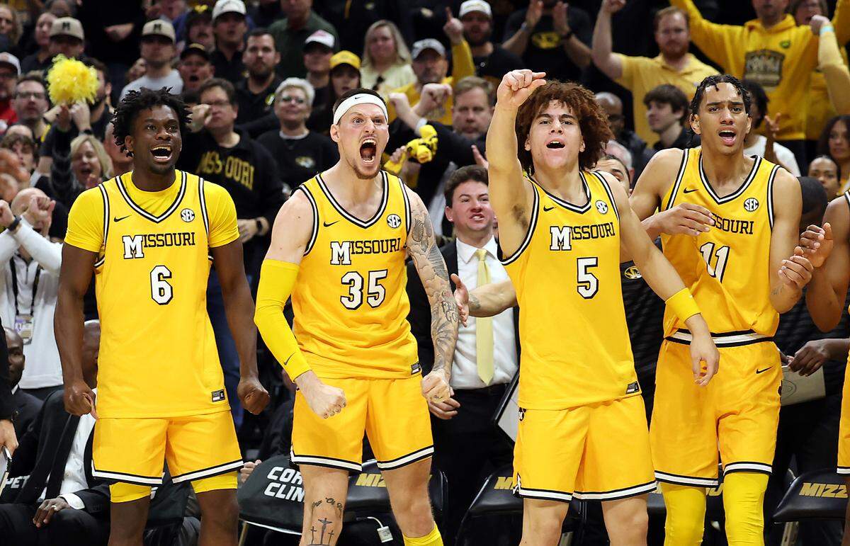 Annor Boateng #6, Jacob Crews #35, T.O. Barrett #5 and Trent Pierce #11 of the Missouri Tigers celebrate as the Tigers defeat the Kansas Jayhawks to win the game at Mizzou Arena on December 08, 2024 in Columbia.