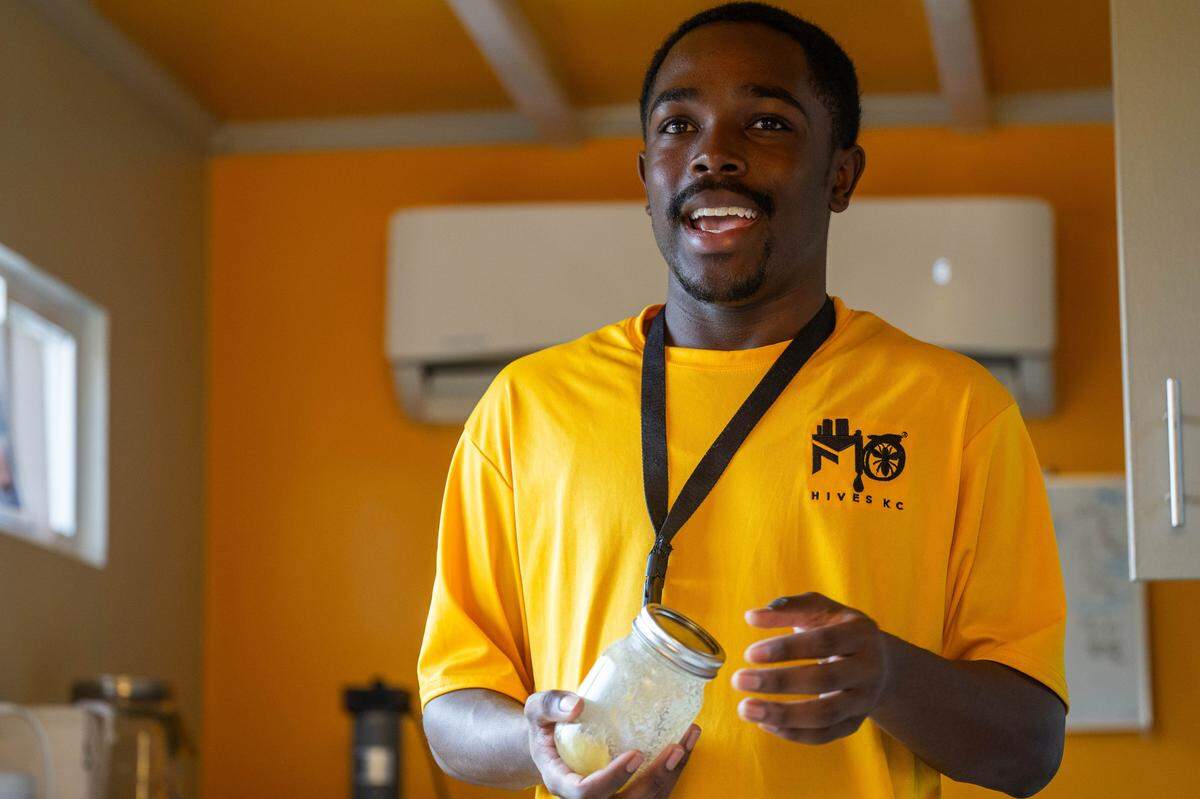 Cameron Ritchie, 16, holds a jar of honey inside the GEHA Garden-to-table test kitchen at MO Hives KC on Friday, October 10, 2025 in Kansas City. Ritchie has volunteered with MO Hives since he was 10 and has always loved nature.
