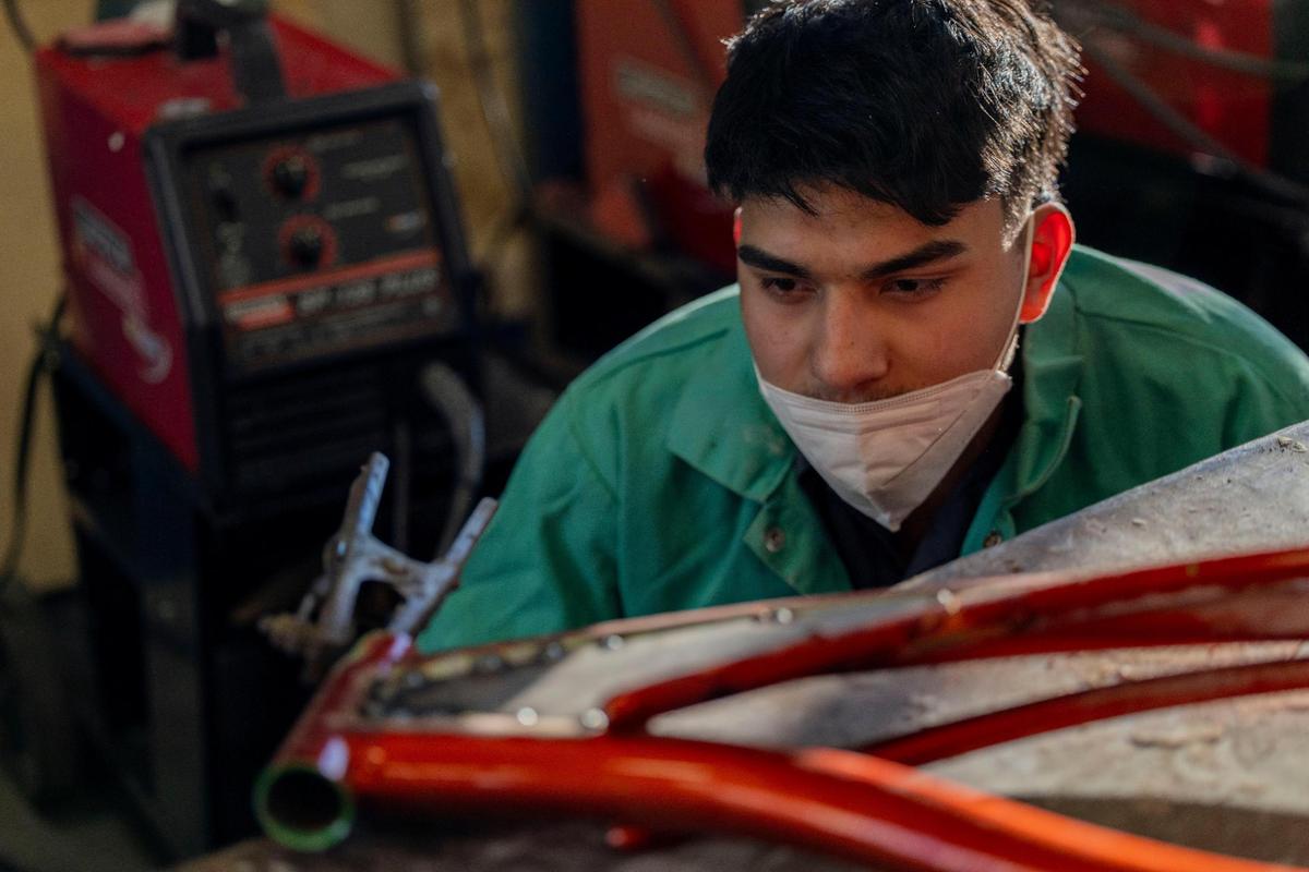 Oswaldo “Ozzy” Polanco, a lowrider bike club member, inspects his new welding on his bike frame at Olathe Advanced Technical Center. Polanco said he is rebuilding his bike to have a better opportunity to enter a lowrider bike competition.
