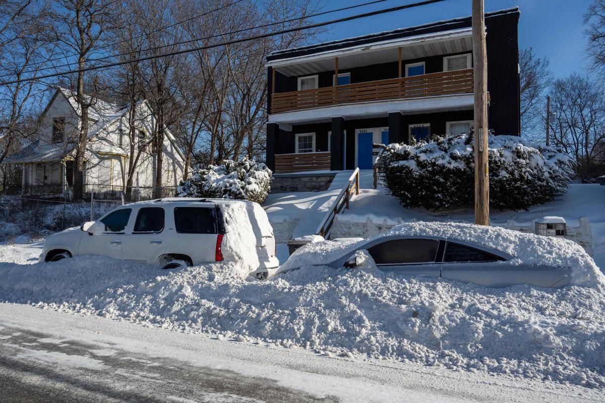 Cars parked along Troost Boulevard were packed in by snowplows on Monday, Jan. 6, 2025 in Kansas City.