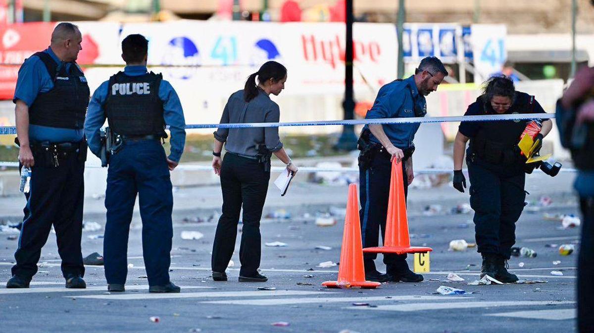 Police officers investigate the scene of a shooting where at least one person was killed and more than 20 others were injured after the Kansas City Chiefs Super Bowl LVIII victory parade Wednesday, Feb. 14, 2024, in Kansas City.