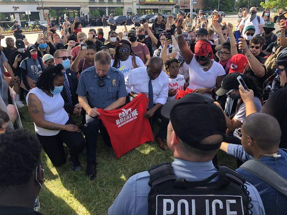 A June 1, 2020, photo shows Kansas City Police Chief Rick Smith and Mayor Quinton Lucas kneeling in a show of unity with protesters at the Country Club Plaza. Smith later told a group of police commanders that he did not believe in the message but acted to silence critics.