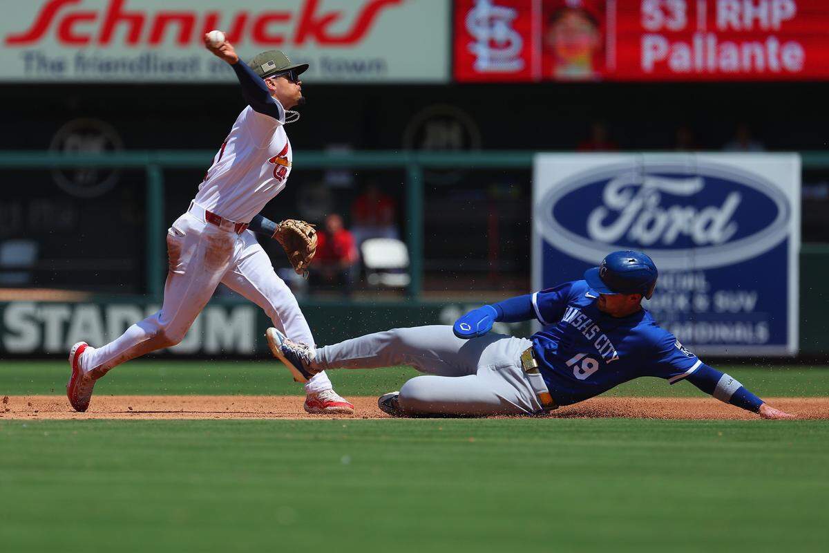 St. Louis’ Masyn Winn, left, turns a double play against the Royals, forcing out Michael Massey, right, during the fifth inning of an I-70 Series finale at Busch Stadium in St. Louis on Sunday, May 17, 2026.
