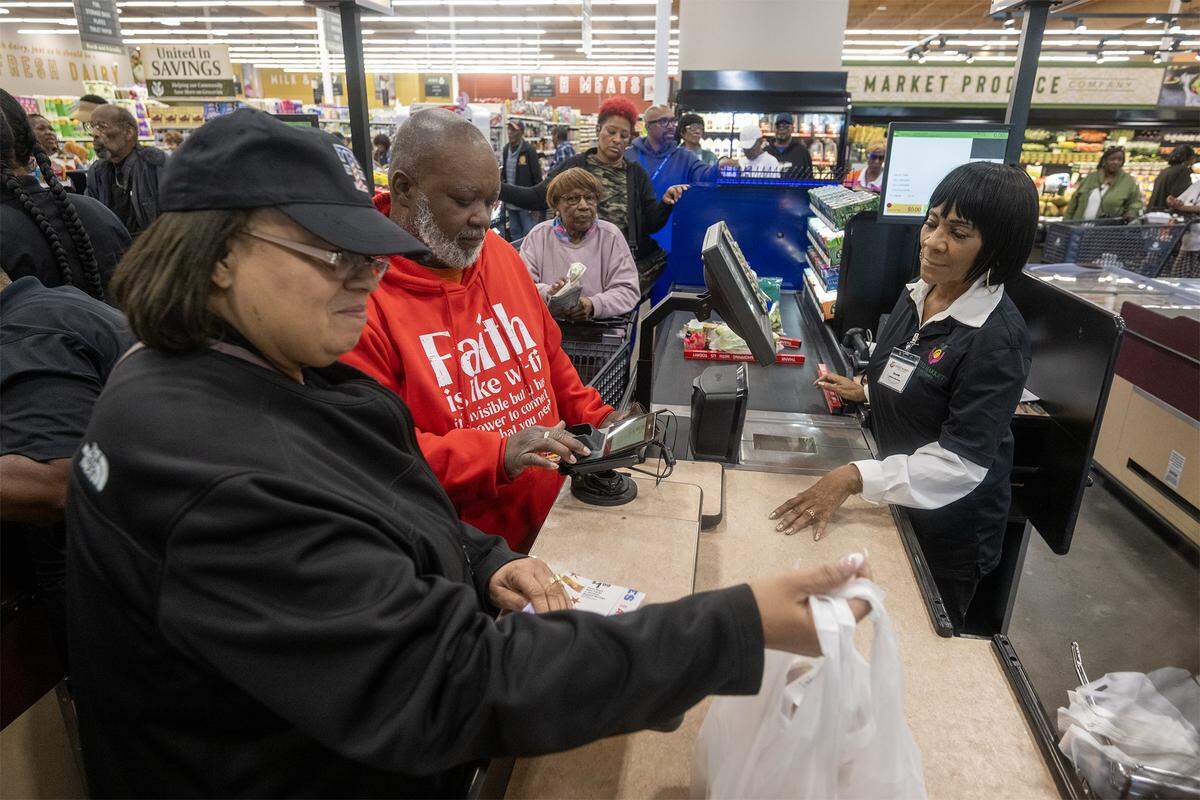 Clair Oatis, an employee at the new United Market, checked out customers after the store's ribbon cutting and a grand opening at 31st Street and Prospect Avenue on Wednesday, May 20, 2026, in Kansas City. The store replaces the Sun Fresh which closed last August after struggling with rising crime and low foot traffic.