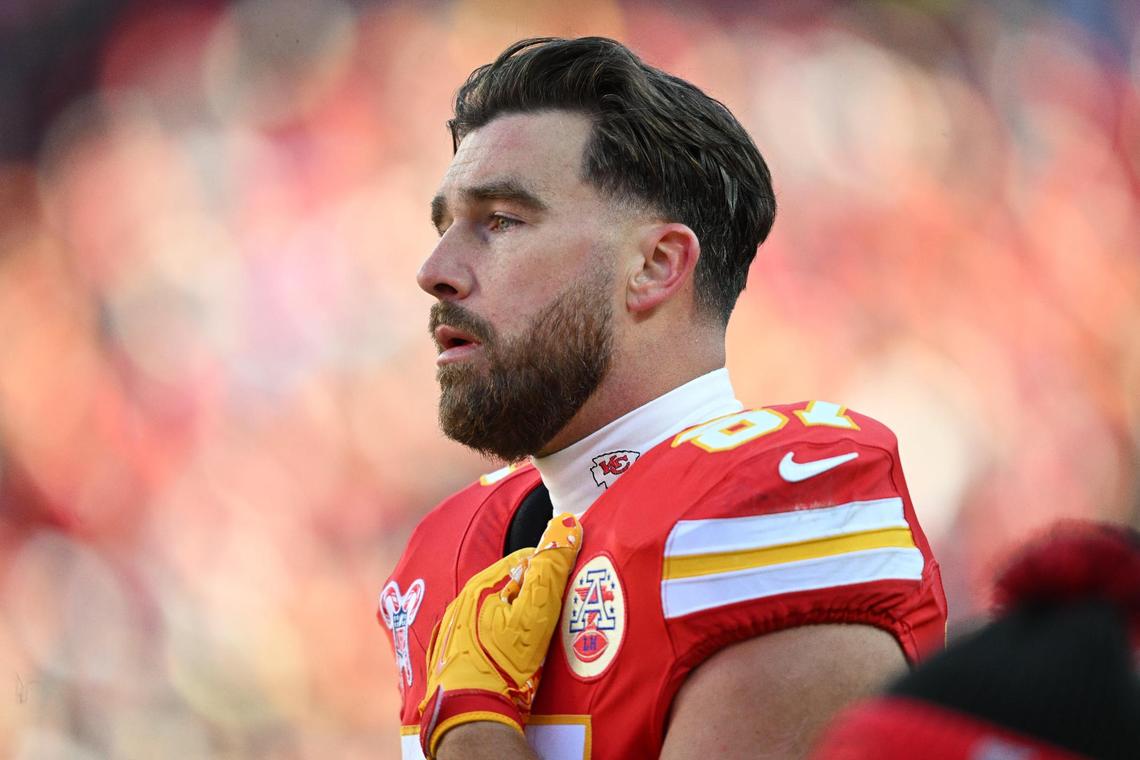 Kansas City Chiefs tight end Travis Kelce (87) watches with concern while medical personnel tend to Houston Texans wide receiver Tank Dell after his knee was severely injured on a touchdown catch in the third quarter on Saturday Dec. 21, 2024, at GEHA Field at Arrowhead Stadium.