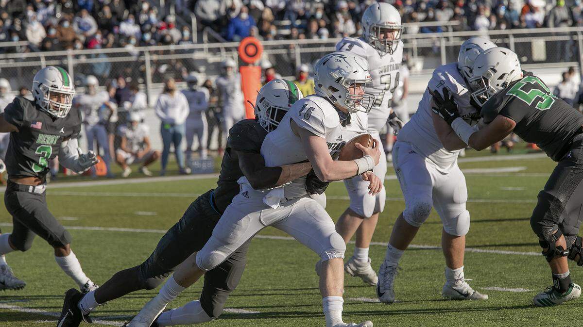 Blue Valley North quarterback Henry Martin is sacked by Sam Same of Derby Saturday in the Kansas Class 6A championship game at the College Boulevard Activity Center in Olathe. 