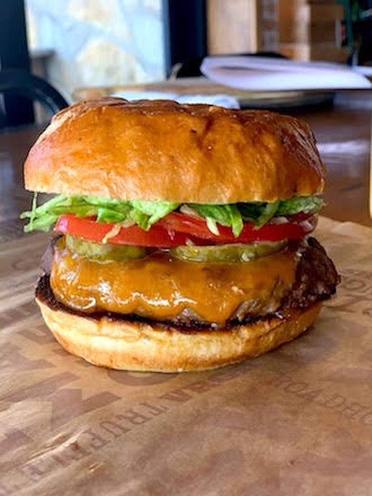 BRGR’s S&P Burger has lettuce, tomatoes, pickles and cheddar on a BRGR seasoned egg bun