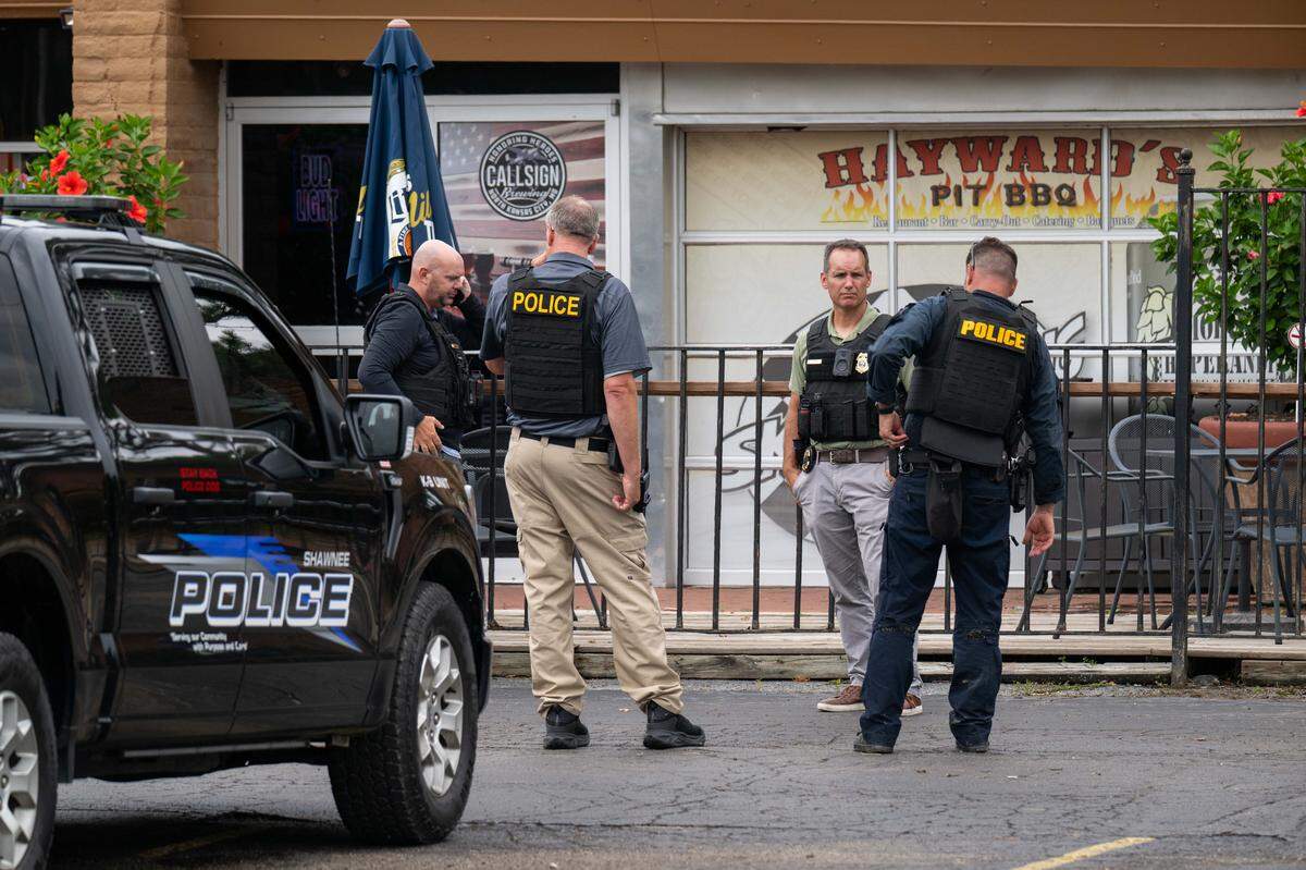 Shawnee Police officers stand outside Hayward’s Pit BBQ following a stabbing incident inside the restaurant on Thursday, July 31, 2025. A suspect was arrested Friday morning, a police spokesperson said.
