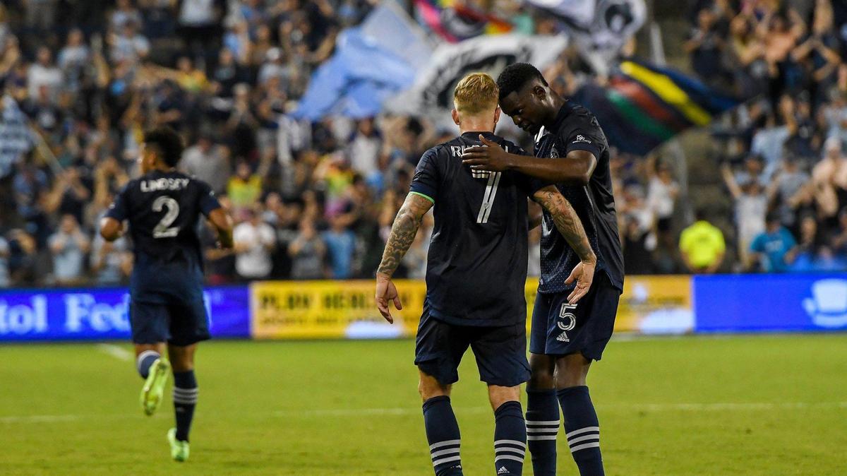 Sporting Kansas City defender Nicolas Isimat-Mirin (5) celebrates with forward Johnny Russell (7) after Russell’s free kick was sent into the goal by forward Dániel Sallói in the second half of the match between Sporting KC and the San Jose Earthquakes at Children’s Mercy Park Wednesday, July 21, 2021. The final score was 1-1.