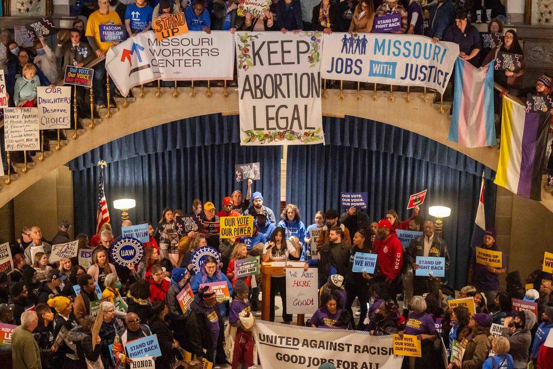 Protesters hold signs as Ashley Jaworski speaks in the Missouri State Capitol rotunda on Wednesday, January 21, 2026 in Jefferson City. Organizations and allies gathered to protest recent Missouri lawmaker's decisions.