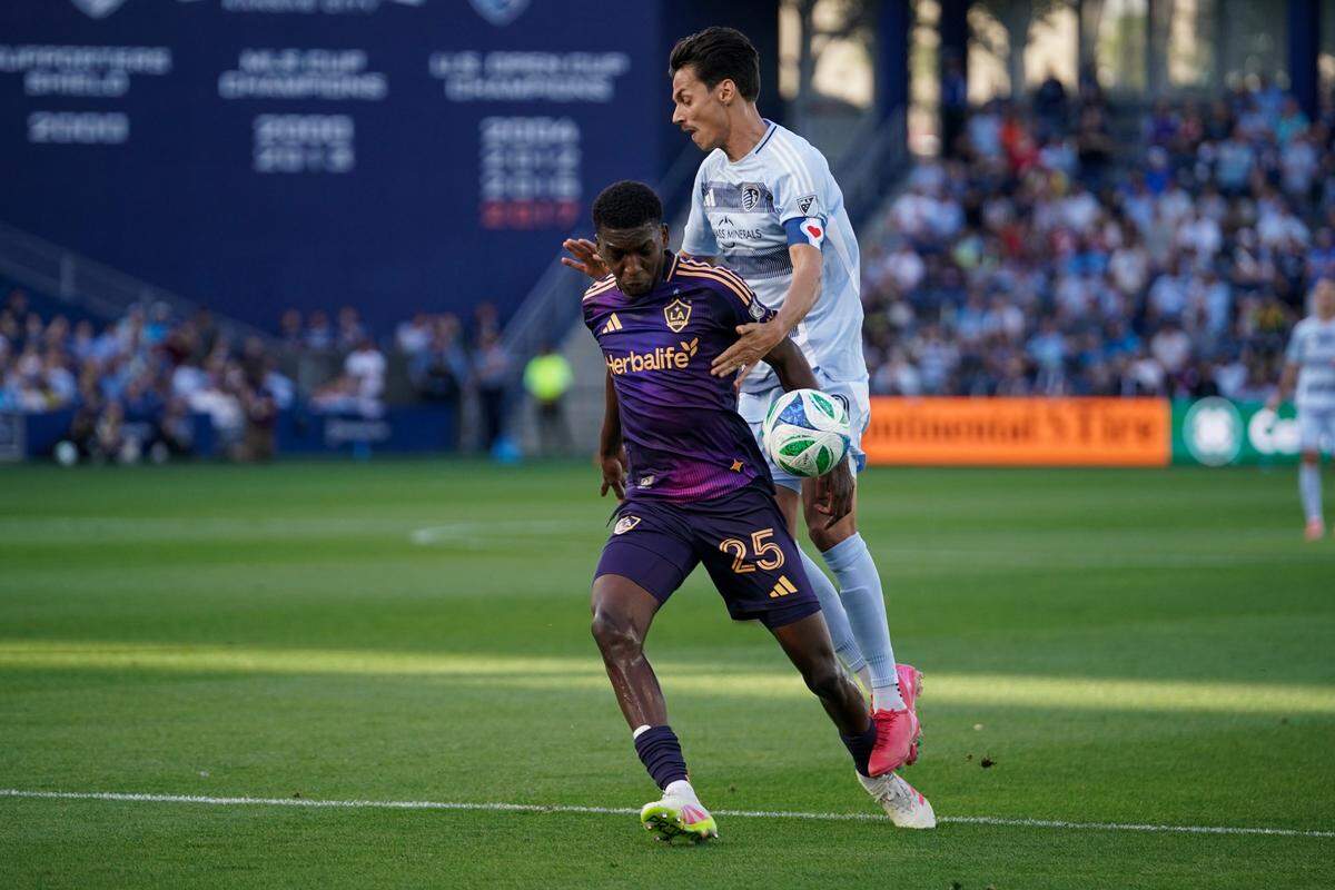 Sporting Kansas City’s Daniel Salloi, at rear, battles L.A. Galaxy defender Emiro Garces for the ball on Sunday, May 4, 2025 at Children’s Mercy Park in Kansas City, Kansas.