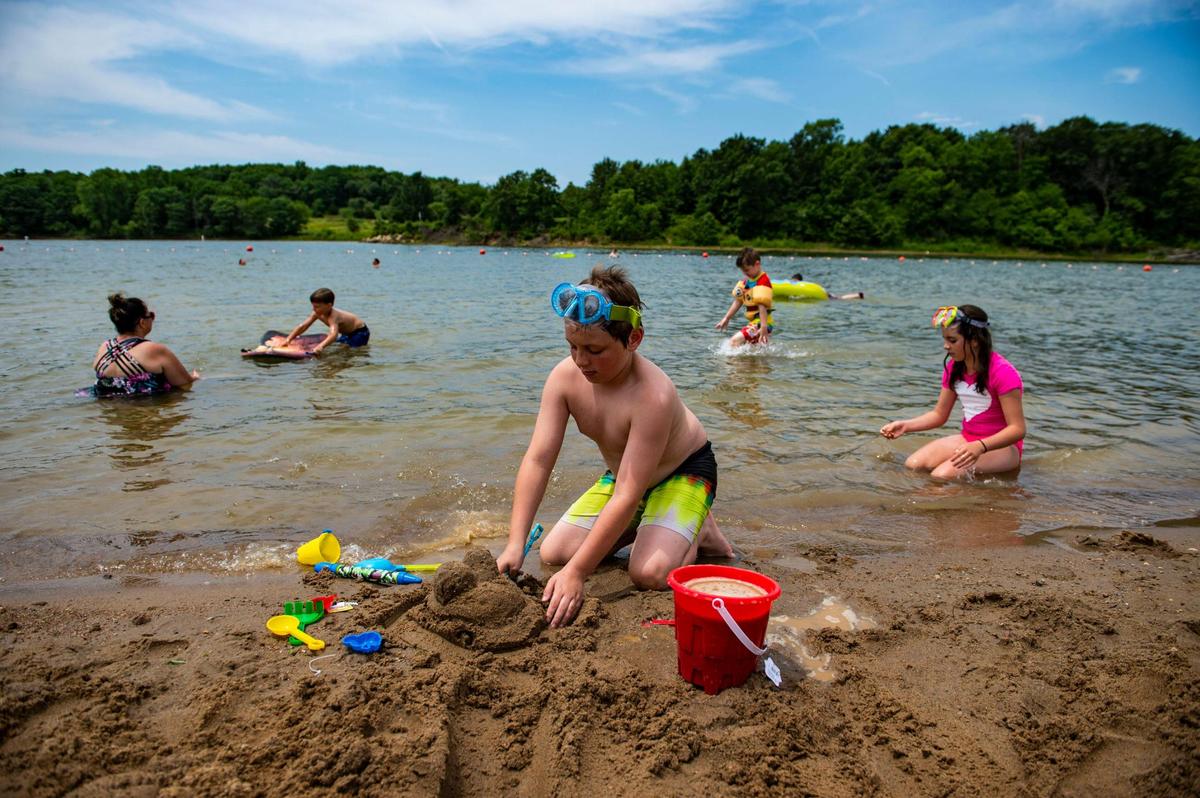 Javen Cox, 9, plays in the sand at Little Platte Beach at Smithville Lake. It was the first time he and his family have been there this season.