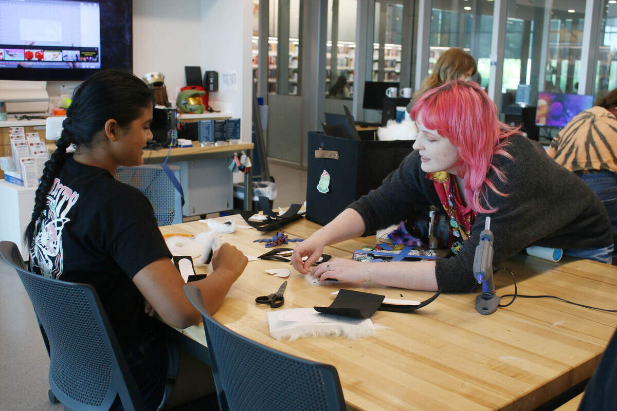 Tvisha Gupta, 11, gets some help from Makerspace specialist Berkley Cyman during a cosplay workshop at Indian Creek Library.