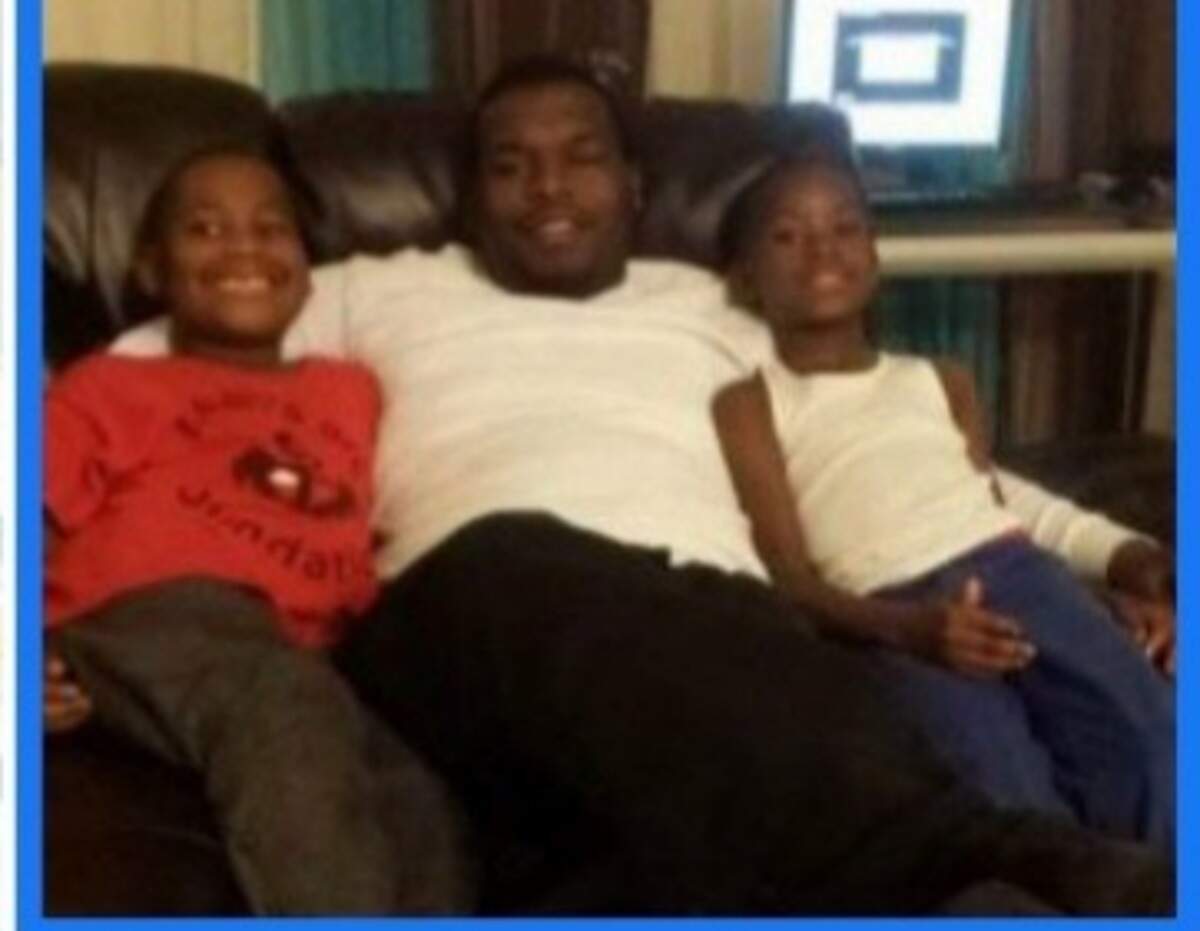 Terrance Bridges, center, sits with his two sons. His sons are now 13 and 12 years old.