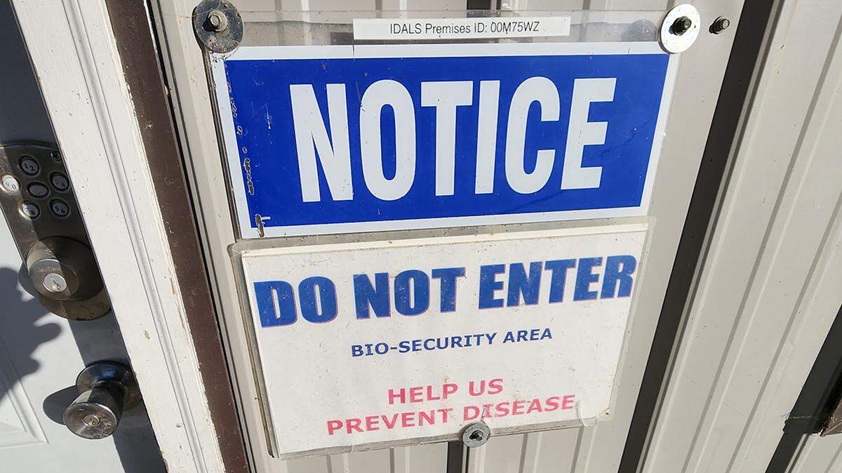 A sign on a door at Arlyn Kauffman's poultry farm aims to fight the spread of bird flu.