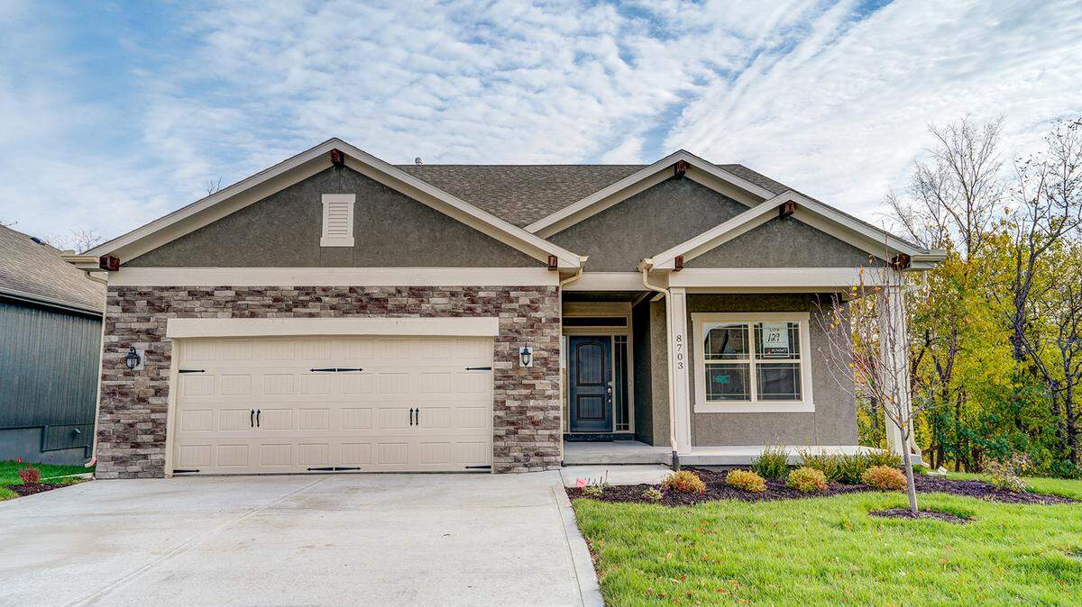 These two-car garage Care-Free Villa plans have three available exterior design options. The Tuscan front elevation is featured here.