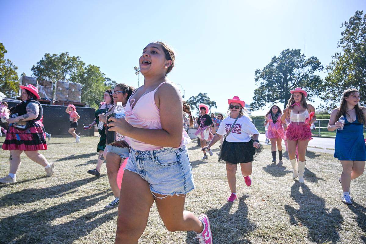 Fans run to be first in line at the gate before the Chappell Roan concert on Saturday, Oct. 4, 2025, at the National WWI Museum and Memorial in Kansas City.
