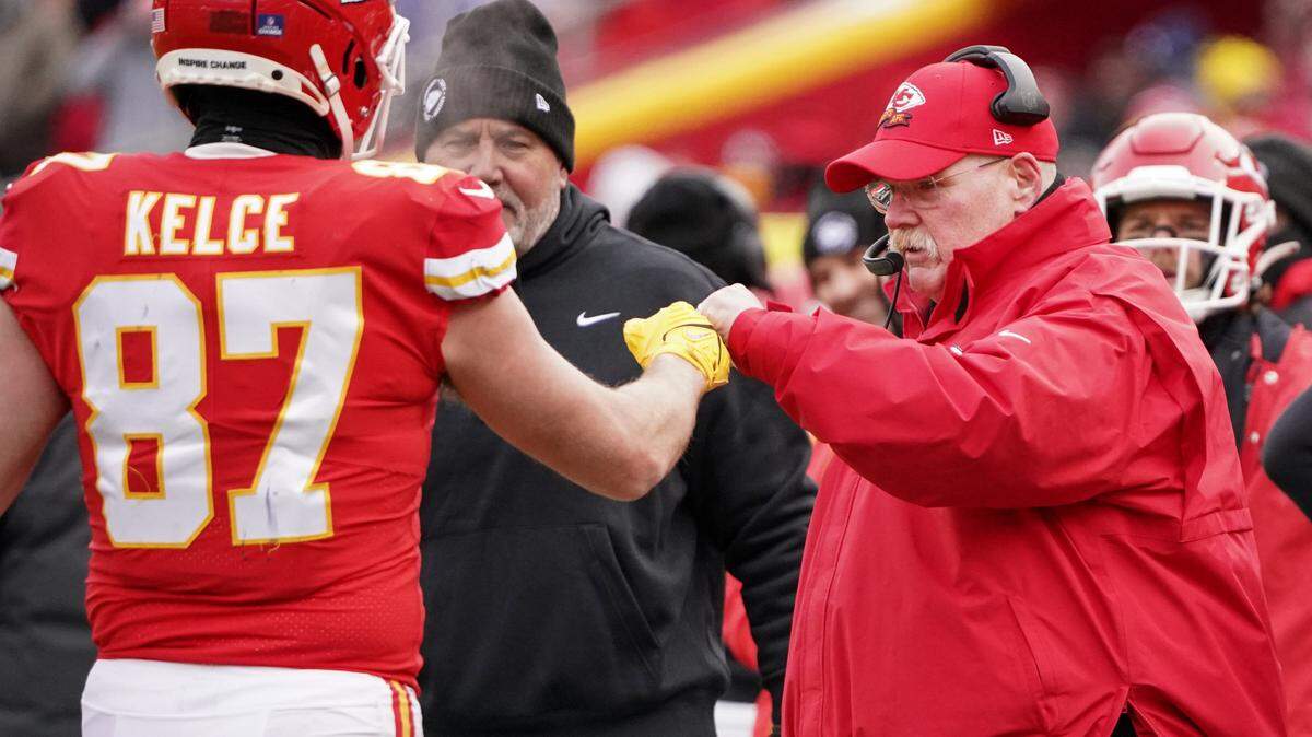 Kansas City Chiefs head coach Andy Reid fist bumps tight end Travis Kelce (87) after a score against the Seattle Seahawks during the second half at GEHA Field at Arrowhead Stadium.