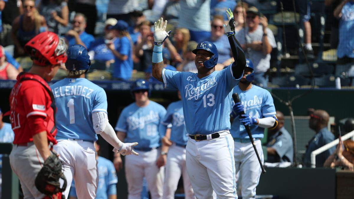 Kansas City Royals catcher Salvador Perez (13) waits to congratulate right fielder MJ Melendez (1) after Melendez hit a two-run home run against the Los Angeles Angels at Kauffman Stadium on June 17, 2023.