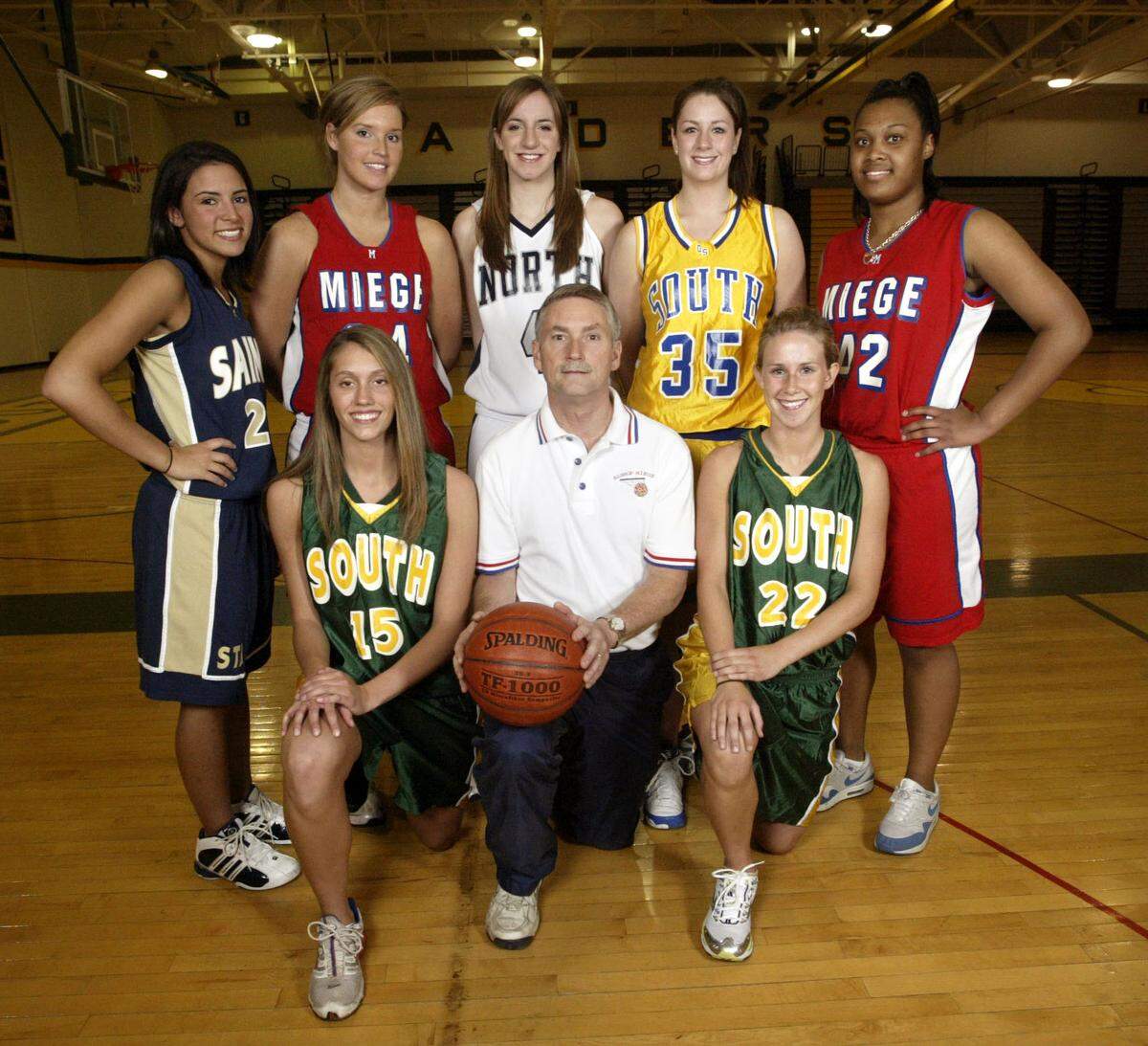 The 2006-07 All-Star Johnson County girls basketball team: Back row, standing, left to right: Kelsey Hill, St. Thomas Aquinas; Emily Gibson, Bishop Miege; Hillary McCormick, Blue Valley North; Jadhon Kerr, Olathe South; and Tierra Ford, Bishop Miege. Front row, left to right: Jocelyn Cummings, Shawnee Mission South; coach Terry English, Bishop Miege; and Kelce Goebel, Shawnee Mission South.