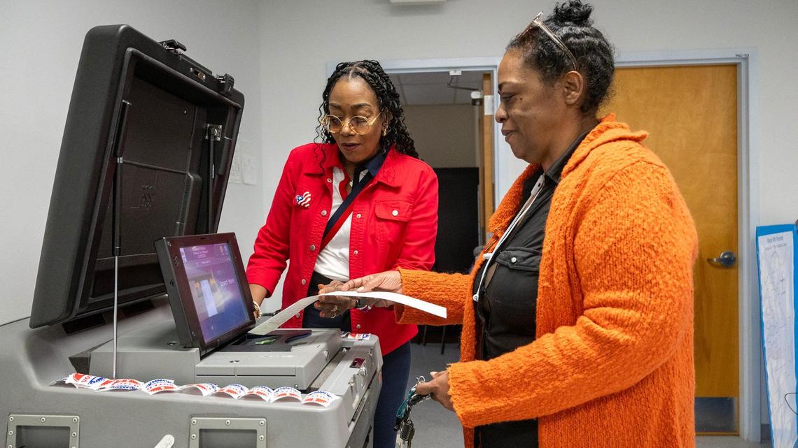 Lauri Ealom, left, the Democratic co-director of the Kansas City Board of Election Commissioners, helped Arrion Abernathy of Kansas City as she inserted her ballot into the machine after voting at the Palestine Senior Center on Oct. 22, the first day of no-excuse absentee voting for Kansas City residents.