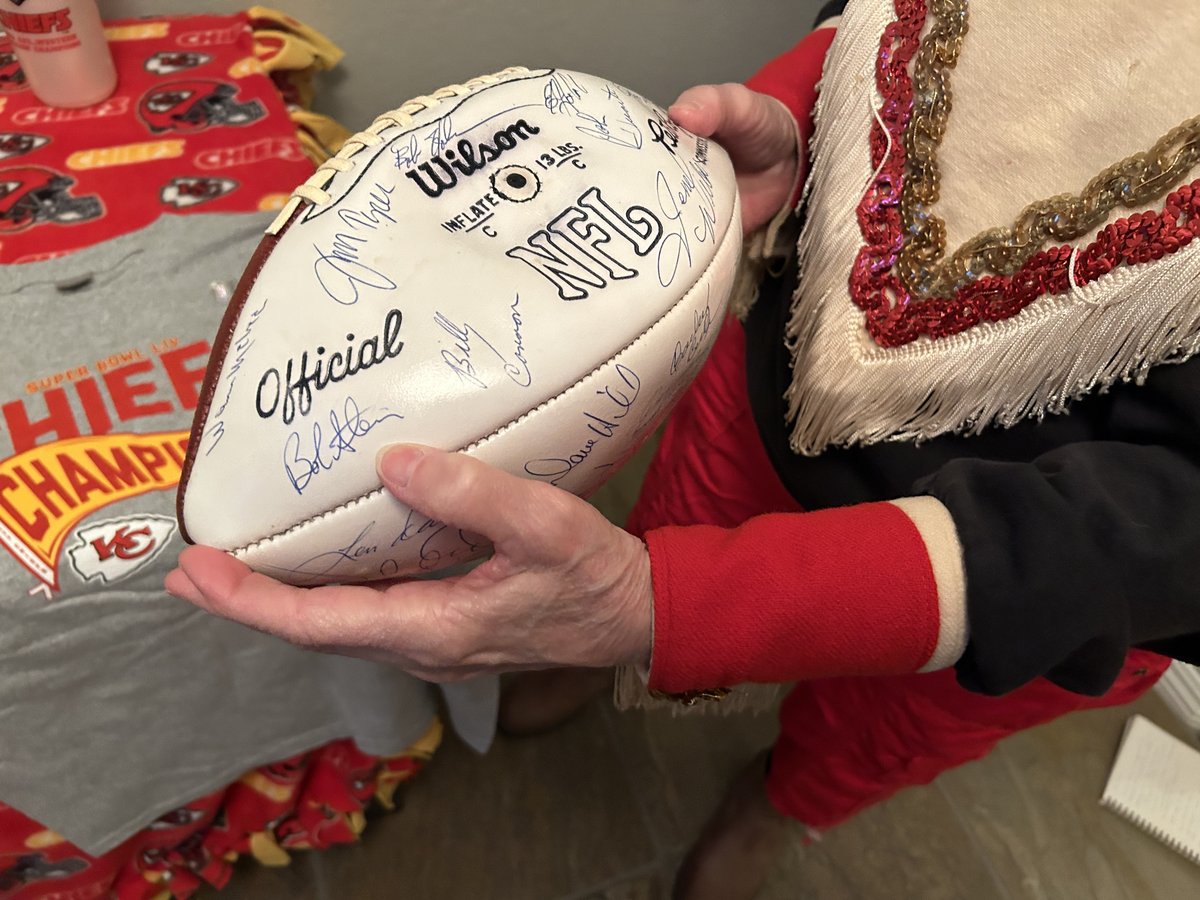Caren Goldberg Movitz shows off a football signed by Chiefs players, including Len Dawson, from her time as a Chiefette dancer. “Lenny Dawson was a sweetheart,” she remembers.