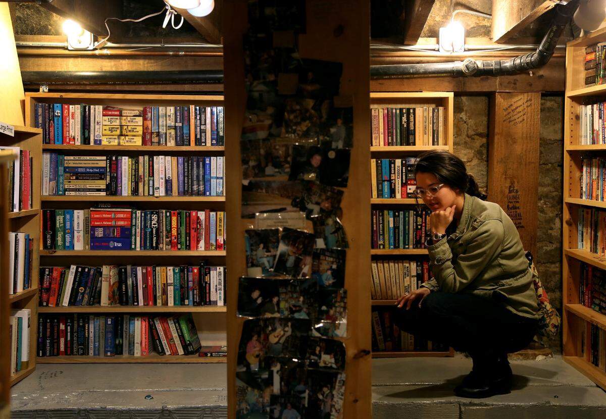 Samantha Gibbs browses books in the basement of Prospero’s on the corner of 39th and Bell streets in Kansas City. The bookstore is a favorite for those who love to browse their diverse collection or tuck away in one of the shop’s many nooks to read.