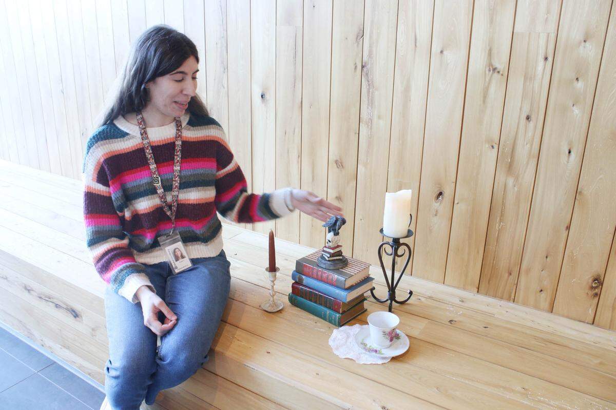 Elaina Finley, adult program specialist at the Olathe Public Library, shows off some of the props she used to make an Edgar Allan Poe-themed escape room.