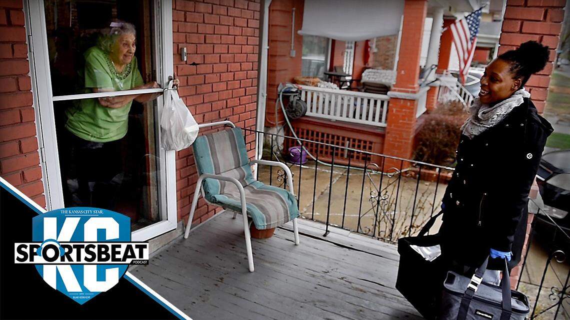 Tee Sexton, who is the kitchen coordinator at Shepherd’s Center, and also delivers hot meals to needy local seniors, greets Carmen Montaro from a distance while delivering a hot meal Thursday in midtown Kansas City. The recent outbreak of COVID-19 coronavirus has required drivers to keep their distance instead of venturing inside to visit and check up on the elderly recipients.
