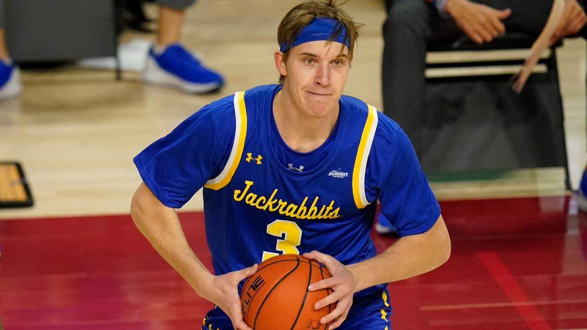 FILE - South Dakota State guard Baylor Scheierman looks to pass during the second half of an NCAA college basketball game against Iowa State, Wednesday, Dec. 2, 2020, in Ames, Iowa. Scheierman has helped South Dakota State win 21 straight games, the longest active streak of any Division I team. (AP Photo/Charlie Neibergall, File)