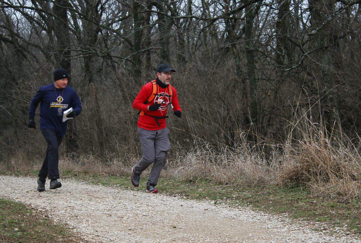 Larry Taft of Kansas City and Galen Spong of Kansas City, Kansas, race to a checkpoint during a Possum Trot Orienteering Club event at the Prairie Center preserve in Olathe.