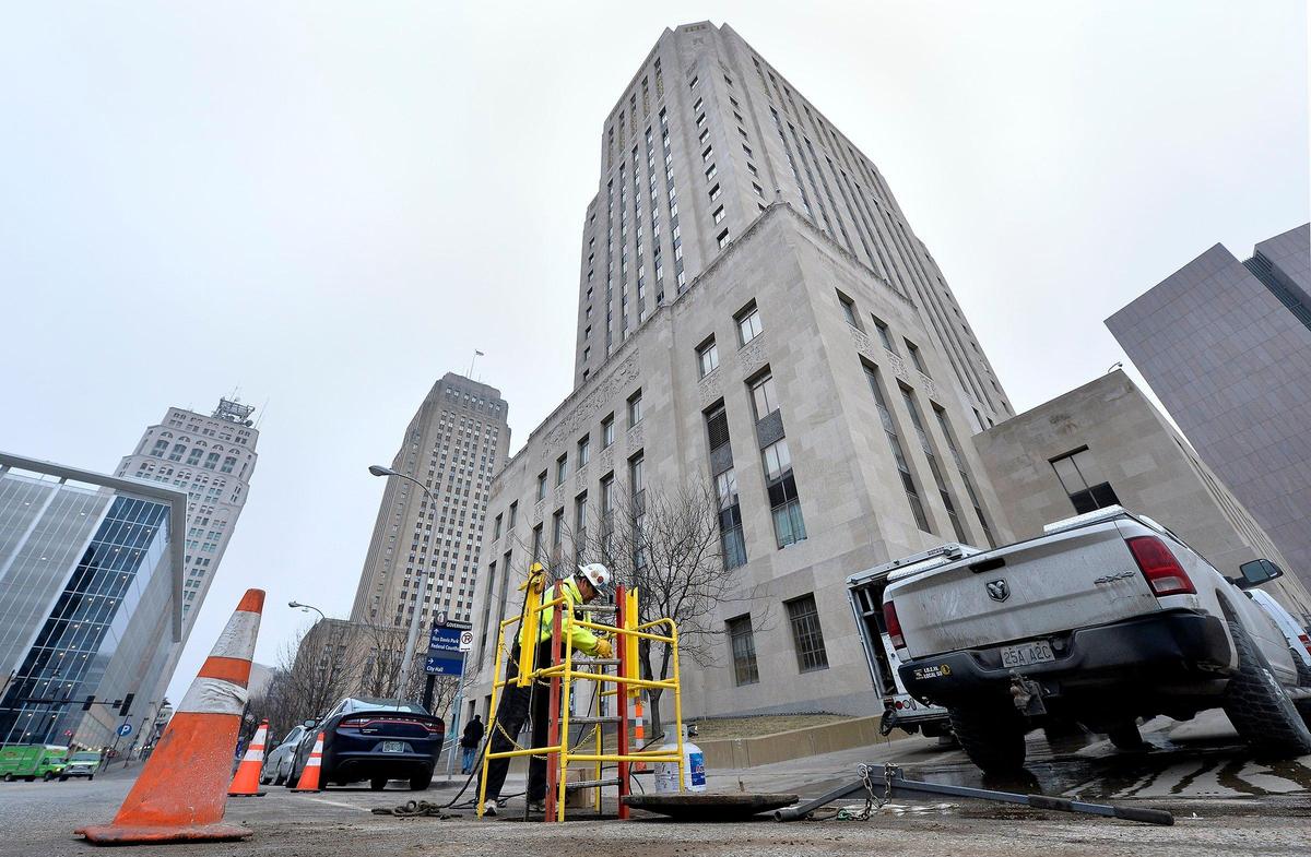 Electricians assess the situation at the Jackson County Courthouse Monday after another water line broke, causing the power to be cut. A broken water line caused the building to be closed last Thursday.