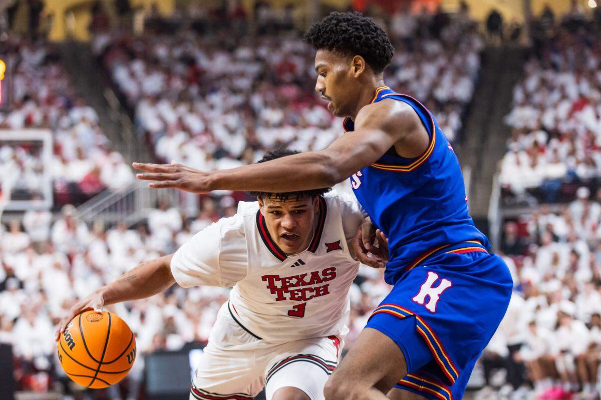 LeJuan Watts #3 of the Texas Tech Red Raiders handles the ball against Bryson Tiller #15 of the Kansas Jayhawks during the first half of the game at United Supermarkets Arena on Feb. 2, 2026 in Lubbock, Texas.