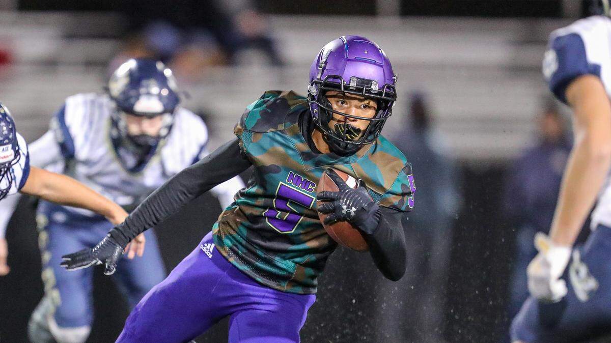 North Kansas City wide receiver Chase Porter (5) runs the ball in between William Chrisman defenders during first quarter action of the game on October 29, 2021, in North Kansas City, MO.