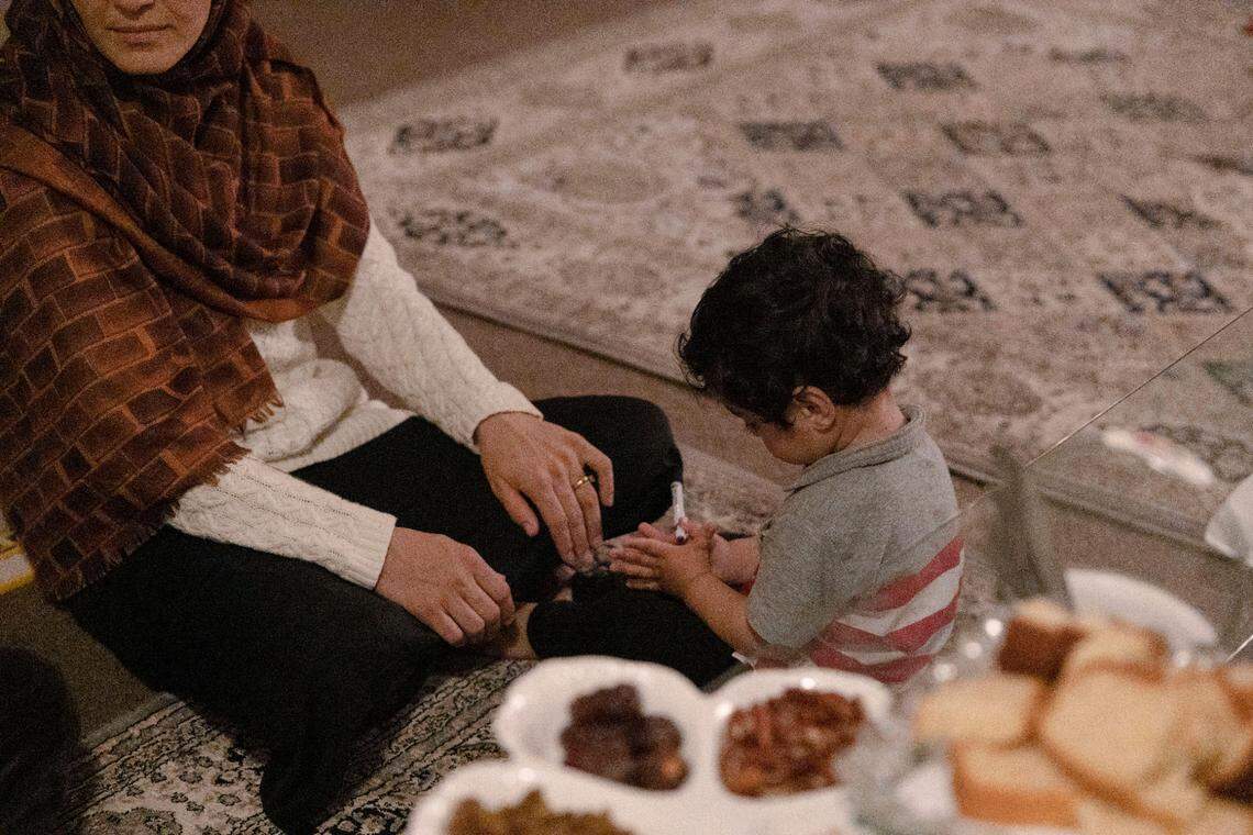 Afghan evacuee Aisha and her 18-month-old son live in an overcrowded apartment with their extended family in Kansas City.