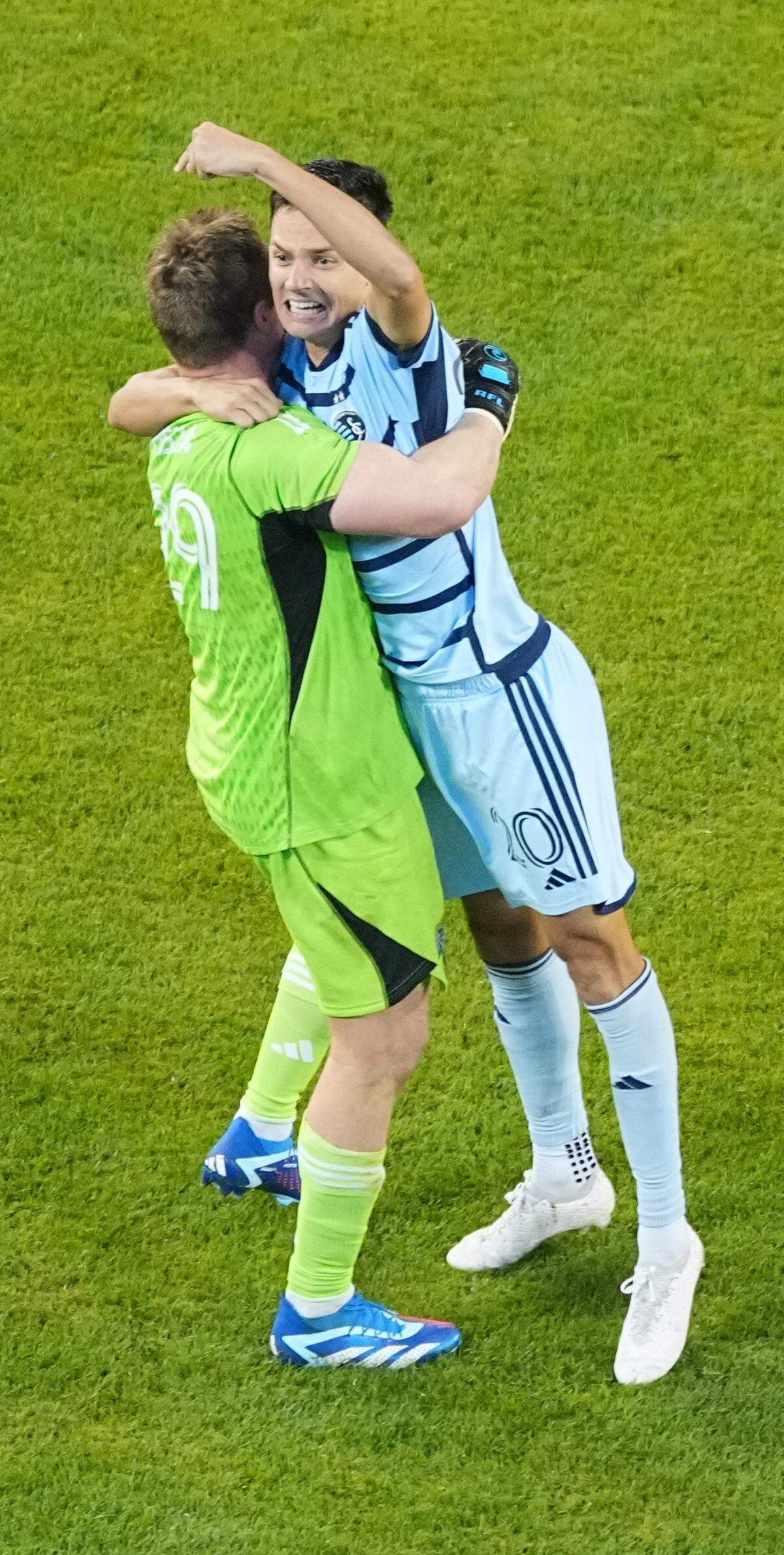 Sporting Kansas City forward Daniel Salloi, with fist raised, celebrates Wednesday night’s playoff victory with goalkeeper Tim Melia at Children’s Mercy Park.