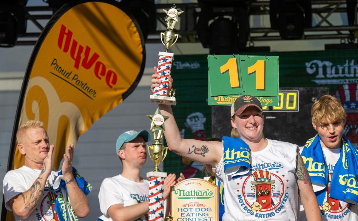 Jocelyn Young of Sherman, Texas, held her trophy aloft after winning the women’s division of the Nathan’s Famous Hot Dog Eating Contest during Old Shawnee Days on Saturday, June 7, in Shawnee. Young ate 11 1/4 hot dogs in 10 minutes.