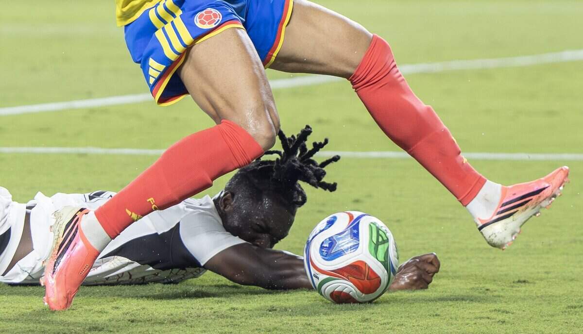 Ghana defender Alidu Seidu (2) falls to the ground while being challenged for the ball by Colombia forward Luis Díaz (7) during a FIFA World Cup knockout stage soccer match at Kansas City (Arrowhead) Stadium in Kansas City on Friday, July 3, 2026.