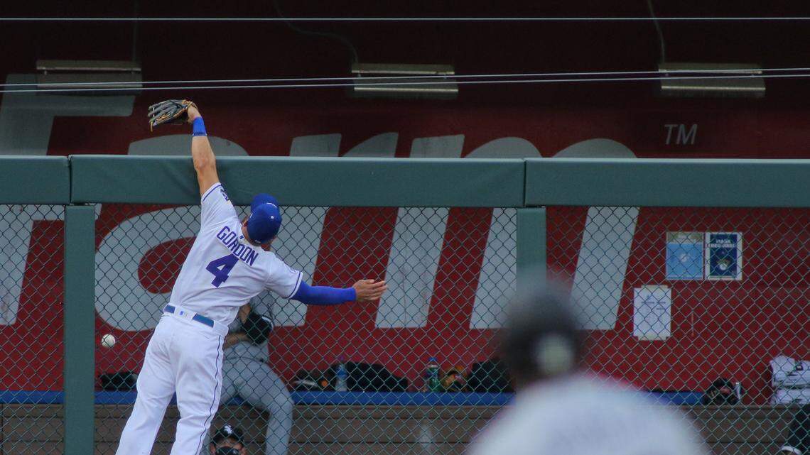Leaping against the outfield fence, Alex Gordon watches Adam Engel’s home run land in the Chicago White Sox bullpen Friday night at Kauffman Stadium. The three-run shot in the second inning gave the White Sox an early lead.