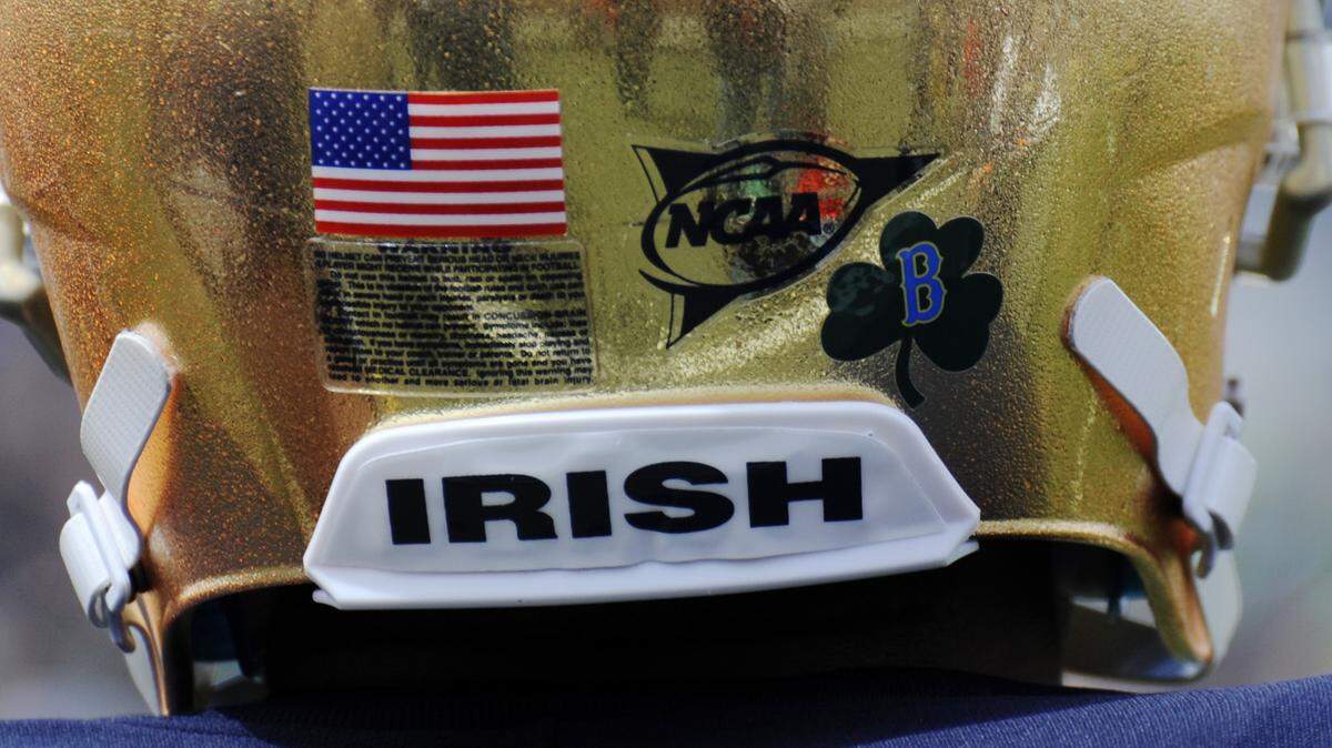 In this April 20, 2013, file photo, to honor those injured and killed in the Boston Marathon bombings, Notre Dame players wore helmets with a B and a shamrock logo on them during the Blue-Gold spring NCAA college football game in South Bend, Ind. AP Photo/Joe Raymond, File)