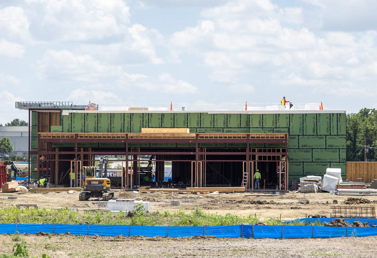 Work crews work at a new Five Four Drafthouse location in the Oldham Village development on Tuesday, July 7.