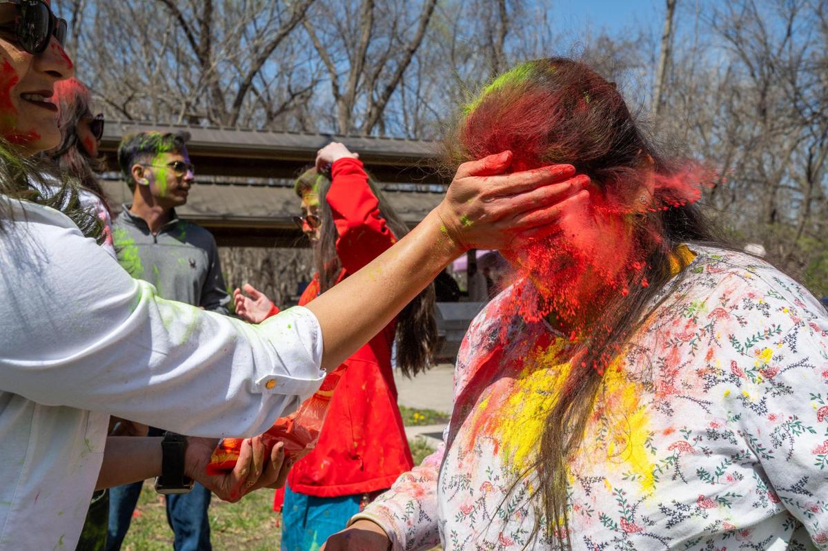 A participant in the Hindu celebration of Holi in Overland Park on Sunday gets her face covered in colorful powder.