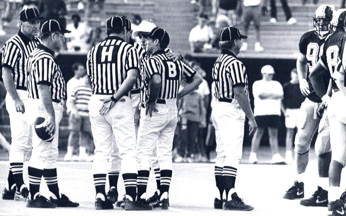 Only after the final whistle had long since sounded in The Fifth-Down Game did a Big 12 official tell Mizzou coach Gary Pinkel, “We blew it.” Here, the referees confer on that fateful day at Faurot Field in 1990.
