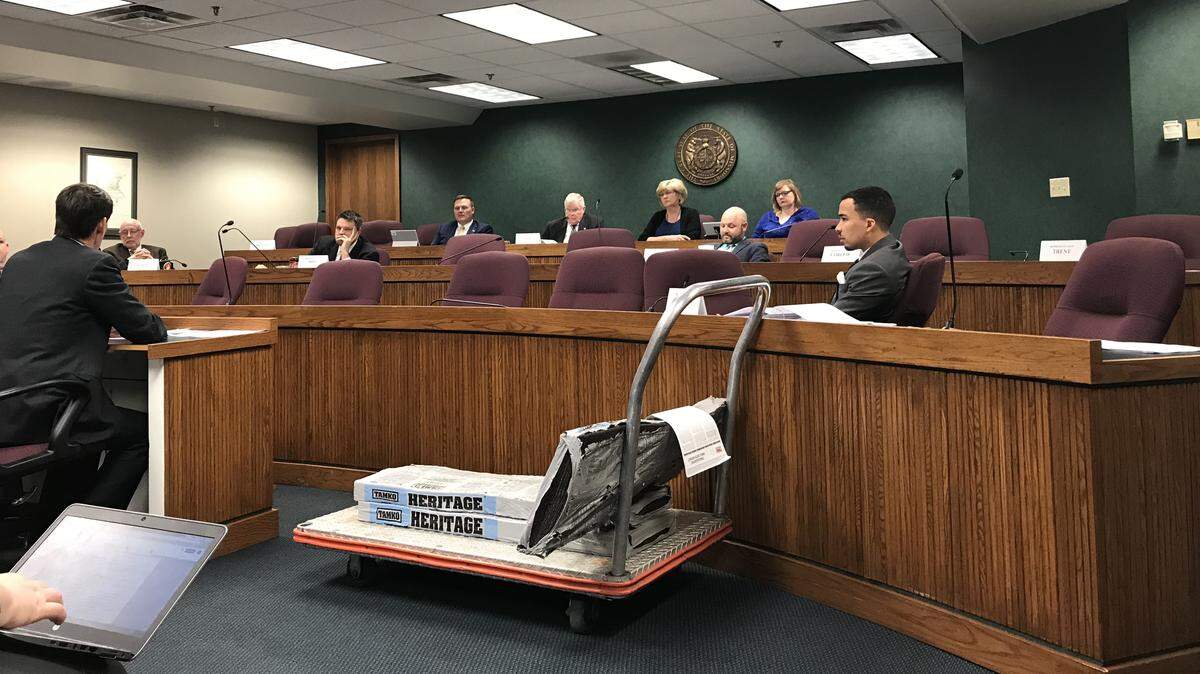 A cart of Tamko Building Products shingles sat at the front of a Missouri House hearing room on Monday. A lawmaker on the committee brought the shingles to draw attention to the company owner's involvement with the issue.