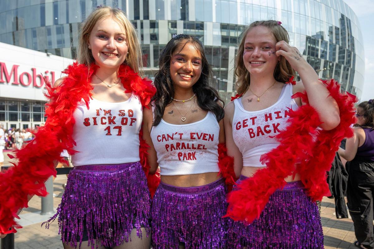 Ava Strella, left, Sareena Kandalkar and Courtney Thompson show off their lyric-themed shirts from the song “Brutal” by Olivia Rodrigo outside T-Mobile Center on Friday, July 26, 2024, in Kansas City.