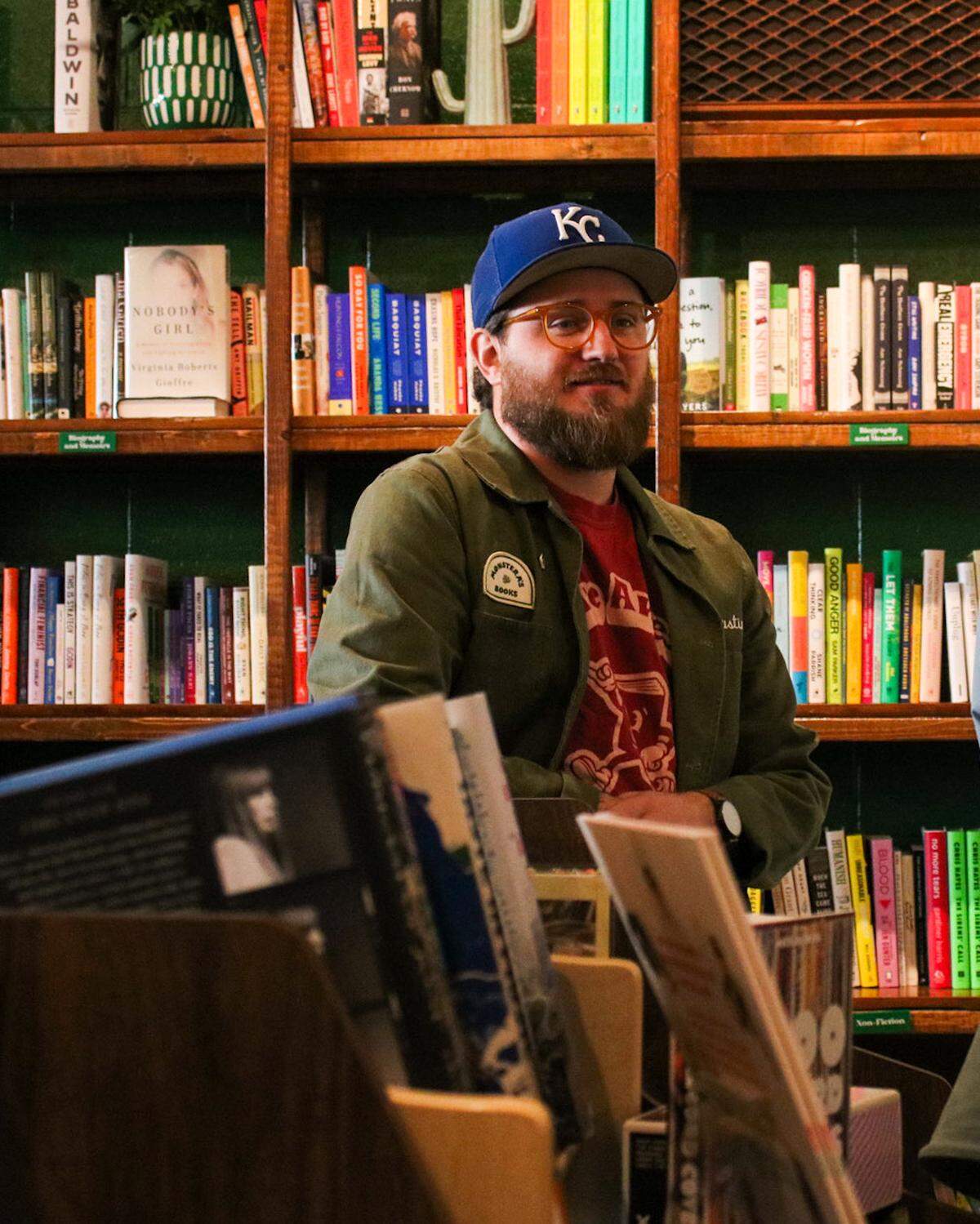 Justin Wieners, 36, interacts with customers at Monstera’s Books at the store’s reopening on Dec. 6, 2025. Justin and his wife Kate Wieners worked for months to reopen the store after a fire damaged the building in August.