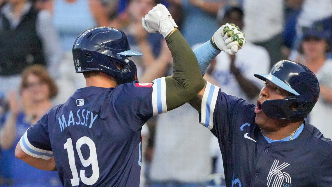 Kansas City Royals second baseman Michael Massey, left, celebrates with catcher Salvador Perez after hitting a two-run home run against the Oakland Athletics on Friday evening at Kauffman Stadium.