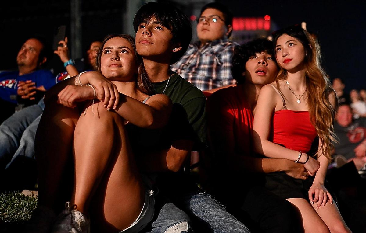 Jayden Hernandez and Kylie David, left, and Jherik Horta and Rose Mai watch the fireworks display during the Stars and Stripes Picnic at the National WWI Museum and Memorial on Tuesday, July 4, 2023, in Kansas City.